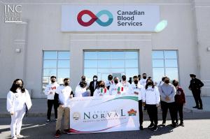 Church Of Christ volunteers posing for group photo in front of Canadian Blood Services location