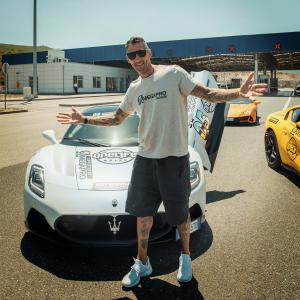 Marco Materazzi poses in front of a OneLife Rally supercar.