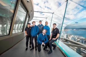 Employees model uniforms on the Space Needle observation deck