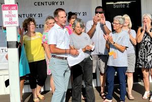 Stephen Votino, CEO/Co-Owner of CENTURY 21 Collection, presented a $500 donation to Caswell Beach Turtle Watch, Co-Coordinators Teresa Putnum and Jamie Lloyd at the grand opening of CENTURY 21 Collective.