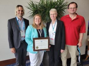 Pictured, L-R: Kyle Bowling, Co-Chair, ASHRAE;  Nadia Sabeh, Co-Chair, ASABE;  Jean Walsh, ASABE Standards Administrator;  Mark Lefsrud, ASABE, PAFS-30 Chair