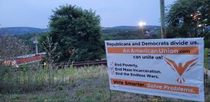 Overlooking the hills of Pennsylvania, a political yard sign for the American Union promotes ending poverty, mass incarceration, and the endless wars.