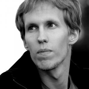 A black and white portrait of visual artist Jocke Larsson