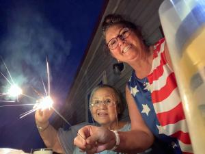90 year old mother Kazuko Regnier with her daughter Joanne Banks hold sparklers