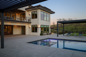 Contemporary Pool Area with Matching Black Louvered Pergolas