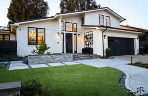 A contemporary front yard showcasing clean lines, dominant hardscape, and an emphasis on structural plantings.