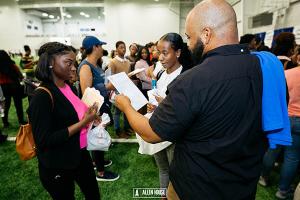 HBCU Week College Fair participant smiles upon receiving her college acceptance & scholarship