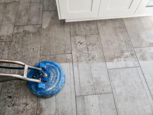 grey wood-style tile and grout being steam cleaned