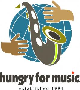 The logo for Hungry for Music, a national non-profit organization that collects and donates musical instruments to children, features a saxopone and globe graphic with hands encircling the globe.  Since becoming a nonprofit in 1994, Hungry for Music has brought healing