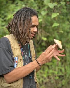 Mycologist William Padilla-Brown Admires a Specimen of Fungi in the Puerto Rican Jungle.