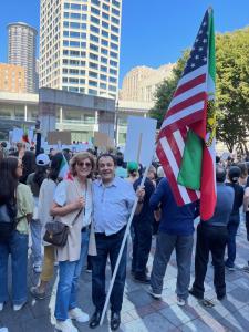 Mr. and Mrs. Hossein Khorram hold American and Iranian flags at the demonstration in Seattle, Washington.