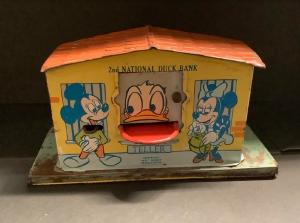 1950s Disney 2nd National Duck Bank mechanical tin bank, featuring Mickey, Minnie, Goofy, Donald, Pinocchio, Figaro, Huey, Dewey and Louie, in good condition (est. $500-$1,000).