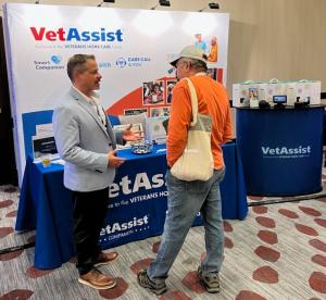 Veterans Home Care executive talks with home care agency owner at FirstLIght Home Care Conference.