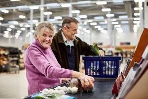 Woman with early stage dementia grocery shopping with her son