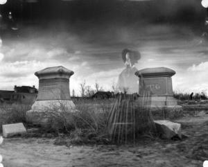 A picture of Cheesman Park Headstones and a Womans Ghostly Apparition in front of them.