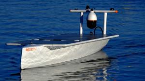 A white autonomous boat moves forward over ocean water