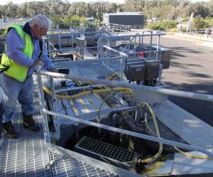 A technician inspects the smoothly functioning new locally manufactured Rotary drum screen and compactor from CST Wastewater Solutions.