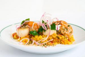 Gulf Shrimp and Scallops with saffron rice, English peas, roasted red peppers, chorizo, and citrus herb butter. Photo Credit: Stephania Campos Photography