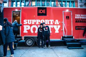 Trailer offering free public toilets is parked on curb in NYC says iDE Support-A-Potty