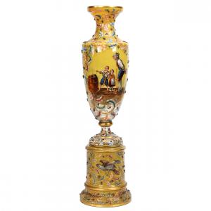 Museum-quality two-piece urn signed Moser, 38 inches tall, yellow opaque art glass with enamel leaf décor and applied acorn highlights. The upper section features a scene of two children ($17,000).