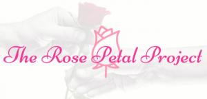 Visit the rose petal project. Hand passing rose to another hand.