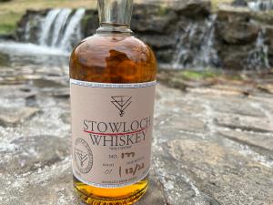 Stowloch Whiskey - In front of a waterfall