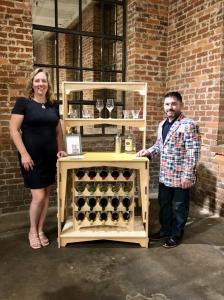 Stewart & Deanna Junge proudly pose with their multi-functional, modular furniture. MOD 5 desk quickly & easily converts to a stylish bar cart complete with wine rack – ready to entertain in minutes!