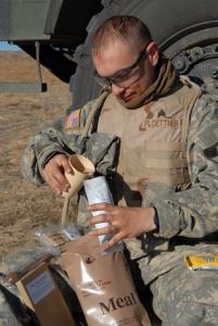 A soldier adds water to his Meal, Ready-to-Eat (MRE). More than 6,000 warfighters have contributed to the MRE improvement program since 1992. U.S. Army photo.