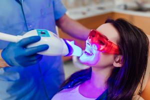 woman having teeth laser whitened