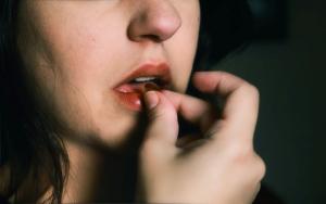 young girl taking a pill