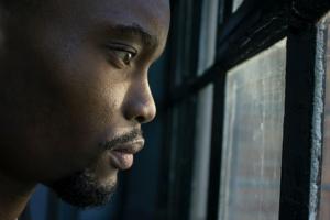 Man looking out window