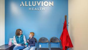 mother and son waiting to be seen at Alluvion Health’s School-Based Health Center