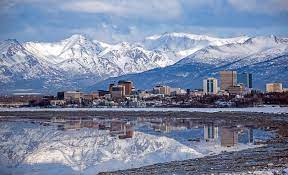 Mountains of Anchorage AK reflecting off the nearby water.