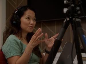 Esther Choy sits in the recording studio for Family IN Business Podcast