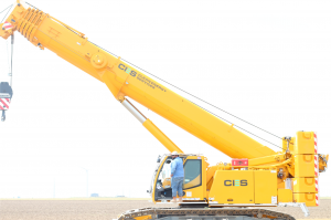 Wind turbine technician operates a crane