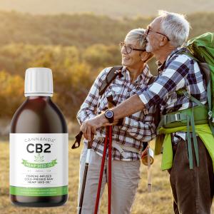 Elderly couple hiking with a bottle of Cannanda CB2 oil (original unflavoured CB2 Hemp Seed Oil)