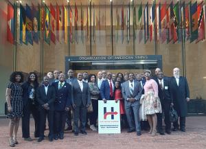 Intergenerational group of Haitians and Friends of Haiti outside of the Organization of American States building during the HPF Haiti National Security & Economic Development Summit