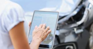 woman using an ipad to review insurance claim information after an auto accident