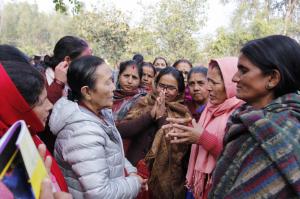 Founder of Maiti Nepal, Anuradha Koirala (in grey jacket) talks with women in Nepal.