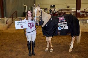 A Texas A7M arena polo player holds her palomino horse Tito for the Nutrena Best Playing Pony award photo