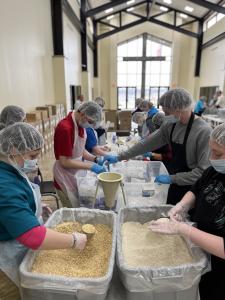 Against Global Hunger volunteers package nonperishable foods.