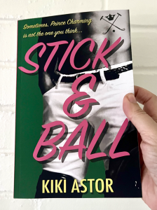 "Stick & Ball": Kiki Astor's sizzling debut! Horses, polo, passion, & scandal in Montecito's ultra-wealthy paradise. Get ready for a wild ride! Image is of "Stick and Ball" book cover in a room with bouquet of pink and yellow flowers behind it.