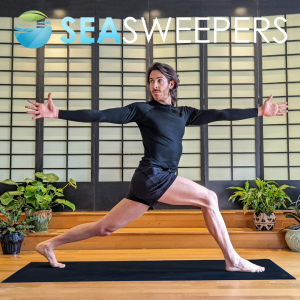 Image of male model doing yoga poses wearing a design by SeaSweepers of their limited upcycled ocean plastic activewear line.