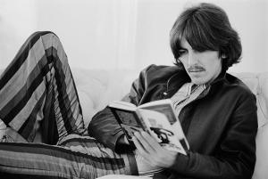 George Harrison reading a book.