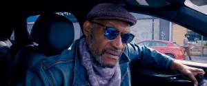 Still image of actor Tony Todd ("Candyman") who stars as "Caddie" in "Traveling Light" in a taxi, searching for his son who has disappeared into LA's tent cities.