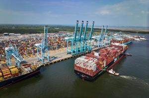 Aerial image showing tugboats guiding container ship into the Port