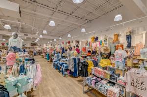 Interior of a Palmetto Moon Store with displays and racks of clothing and accessories