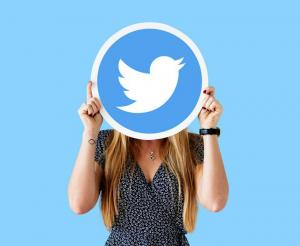 A person holding a Twitter logo