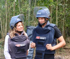 Photo shows World Food Prize Laureate Heidi Kuhn and her son Christian wearing protective gear to visit a landmine site in Vietnam