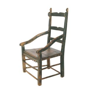 Louis XIII armchair from the Bastien family on the Huron-Wendat reserve in Loretteville, Que., in old green paint with slanted back posts and hand-cut sawtooth skirt (CA$21,240).